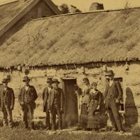 People in front of log post office building